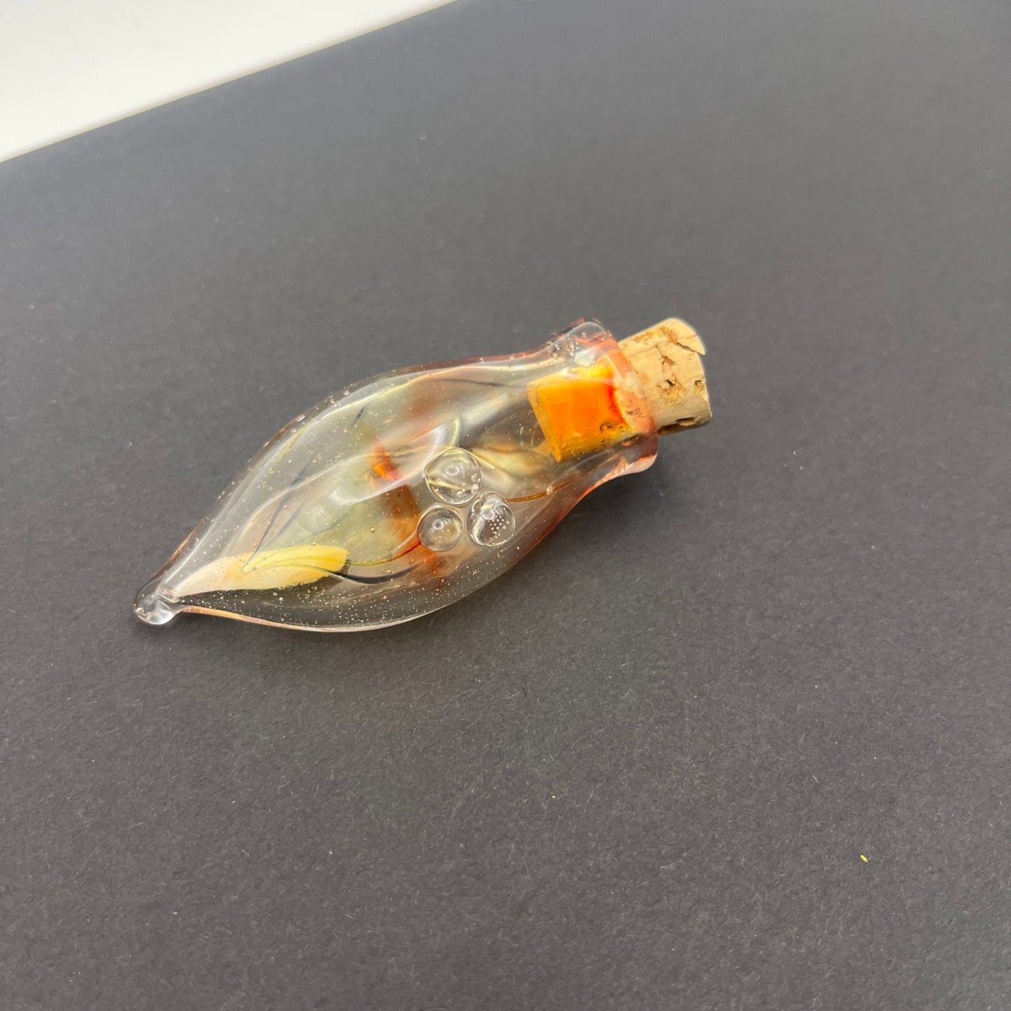 Vulture vial with raccoon tooth