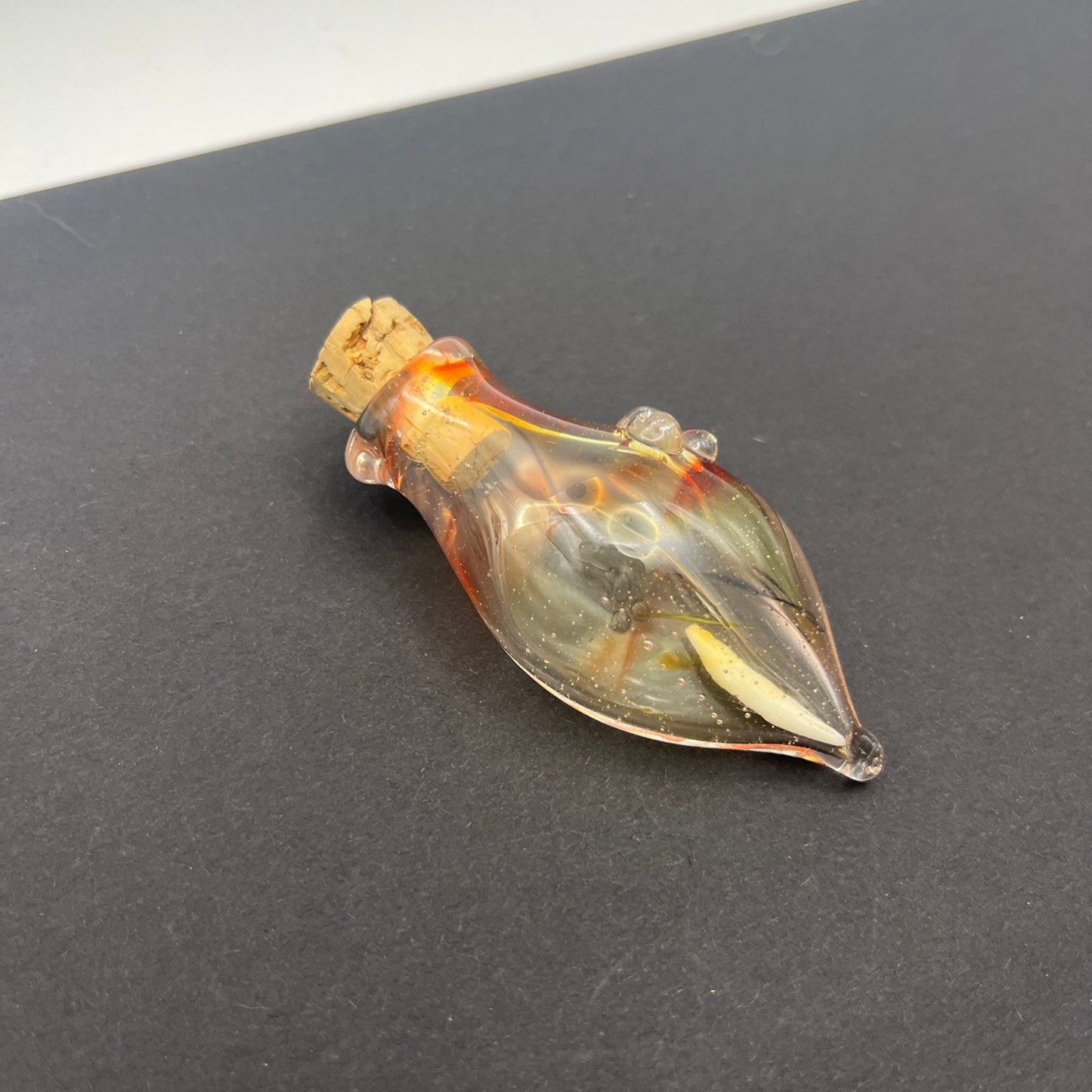 Vulture vial with raccoon tooth